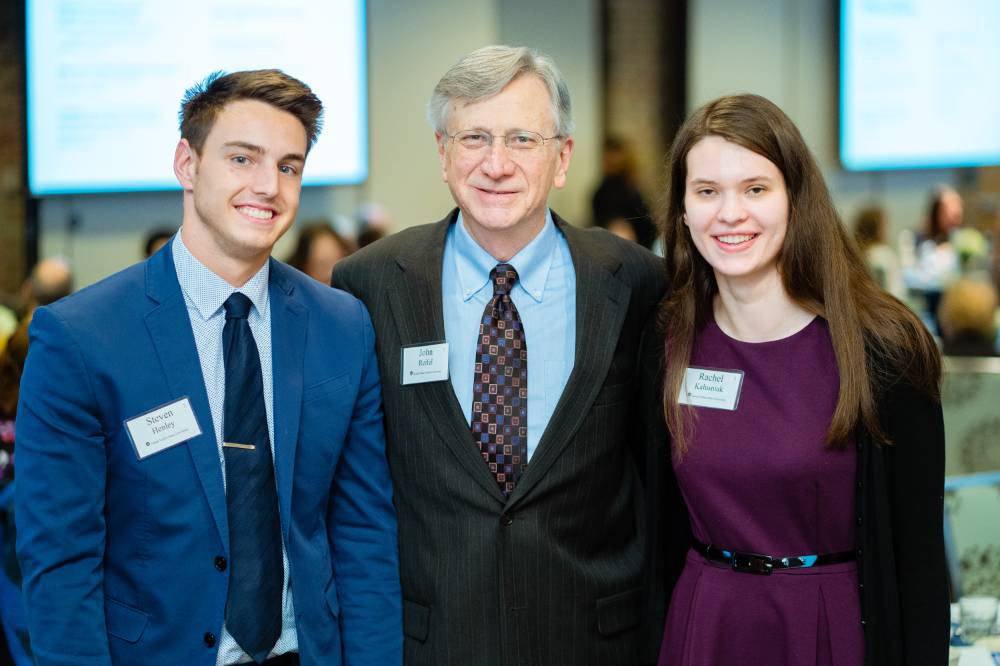 Two students posing with a donor at Scholarship Dinner 2019